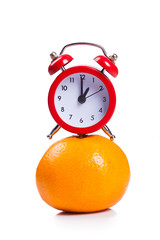 Alarm clock and orange fruit