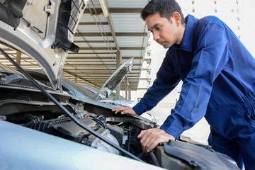 Fototapeta na wymiar Auto mechanic (or technician) checking car engine