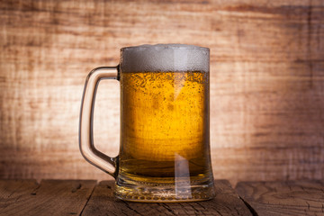 Glass beer on wood background
