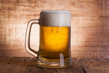 Glass beer on wood background