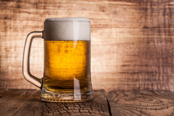 Glass beer on wood background