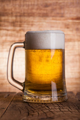 Glass beer on wood background