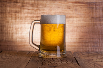 Glass beer on wood background
