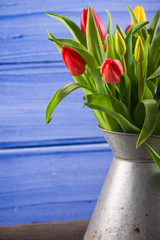 FResh spring bunch of tulips in vintage rusty vase