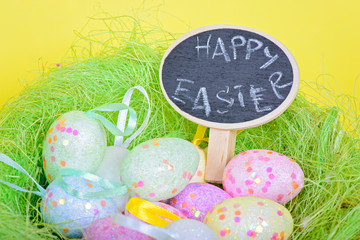 Ester eggs in nest with small chalkboard