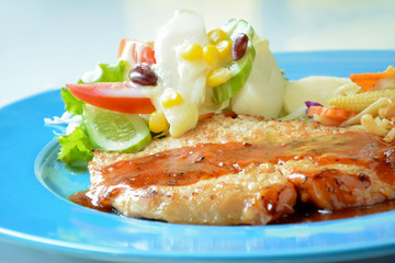 Homemade pan fried pork steak with mix vegetable salad 