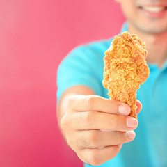 A man giving fried chicken leg or drumstick
