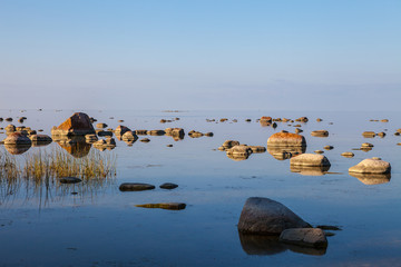 Beautiful stones in the bay of Baltic sea at sunset