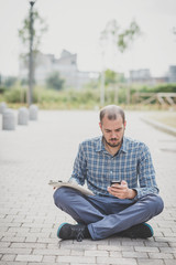 handsome hipster casual multitasking modern man using tablet