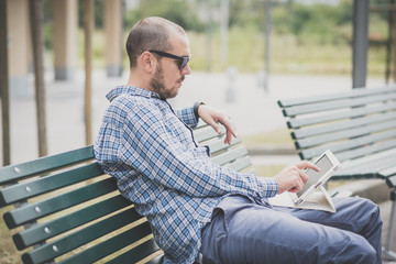 Fototapeta premium handsome hipster casual multitasking modern man using tablet