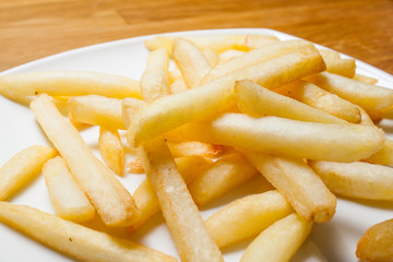 Tasty golden french fries on a plate