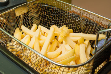 French fries fried in oil golden patato - 78592016