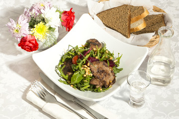 rabbit liver salad with arugula in a restaurant