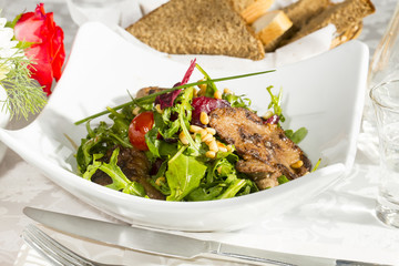 rabbit liver salad with arugula in a restaurant