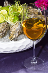 oysters on ice in a dish on a table in a restaurant