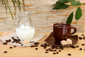 Cup of black coffee and a jug of cream