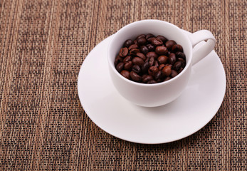 Cup with coffee beans, close up