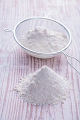 sieve fith white natural flour on vintage wooden desk food and d