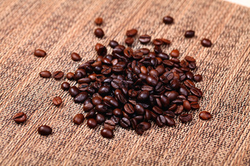 Coffee beans on the brown background