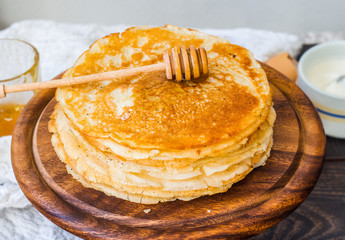 many thin sweet pancakes with honey, breakfast, rustic