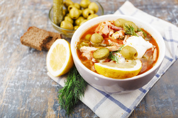 Russian soup Soljanka on a wooden background