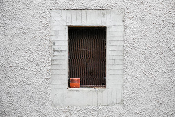 Window framed in whitewashed wall of alley in a village © arkanto