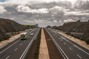 elevated view of a highway with vehicles, cloudy sky