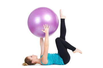 Fototapeta na wymiar Girl-fitness instructor,shows exercises with a large ball.
