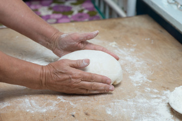 hand with rolling pin and flour