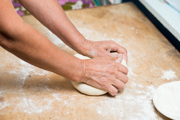 hand with rolling pin and flour