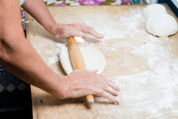hand with rolling pin and flour