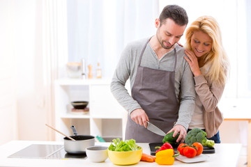 Young attractive couple cooking in a kitchen