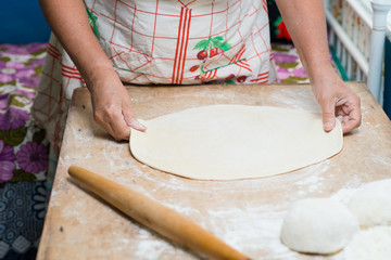 hand with rolling pin and flour