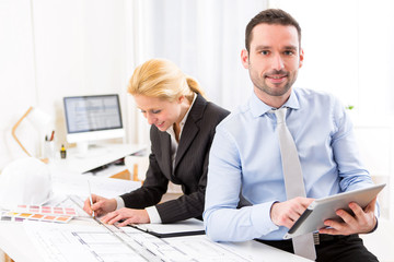 Young attractive engineer working at the office
