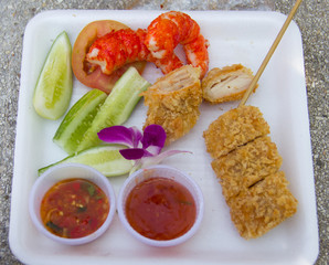 Thai street food close-up with grilled seafood.