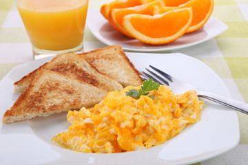 breakfast with scrambled eggs and orange juice