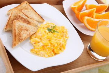 breakfast with scrambled eggs and orange juice