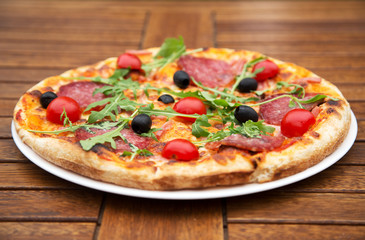 Delicious italian pizza served on wooden table
