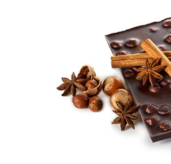 Chocolate and nuts with cinnamon sticks, star anise isolated