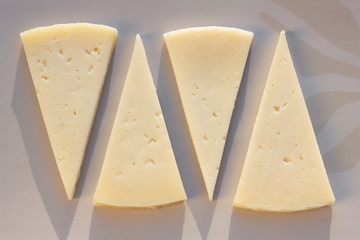 Four slices of semi matured manchego cheese.