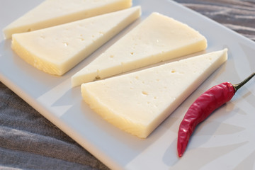 Four slices of semi matured manchego cheese.