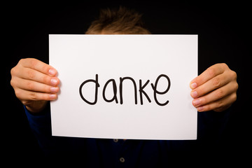 Child holding sign with German word Danke - Thank You