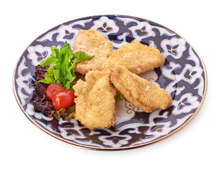 A pile of chicken nuggets on white plate with sauce