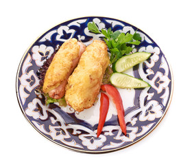 A pile of chicken nuggets on white plate with sauce