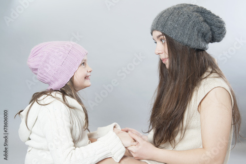 Two Sisters Holding Hands And Looking At Each Other..\ Stock Photo - 500x333 - jpeg Two Sisters Holding Hands