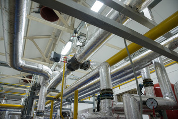 Place in a large industrial boiler room.