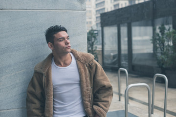 Young handsome man posing in the city streets