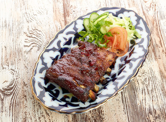 Meat on a grill with vegetables