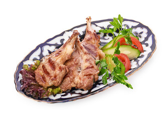 Meat on a grill with vegetables