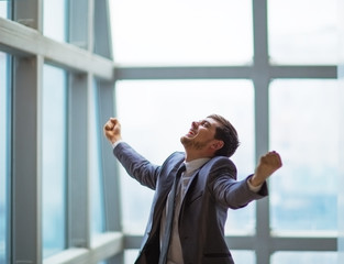 businessman with arms up celebrating his victory